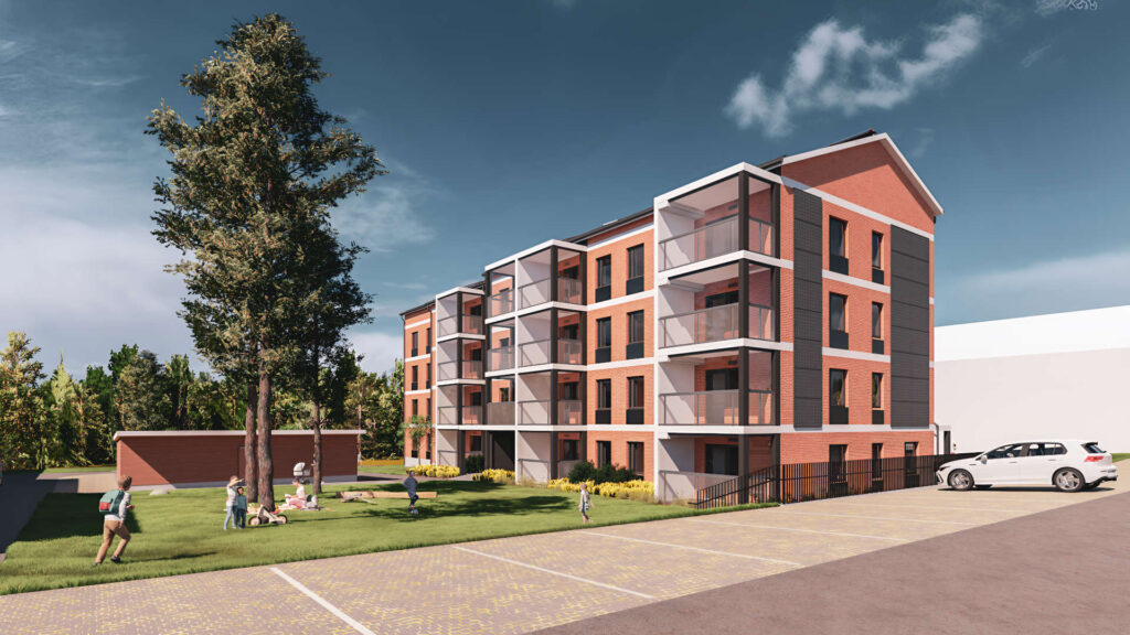 Moderni, nelikerroksinen punatiilinen kerrostalo, jossa on lasitetut parvekkeet. Etualalla nurmialue, jossa ihmiset viettävät aikaa, sekä pysäköintialue autoineen. Taustalla puita ja sininen taivas.