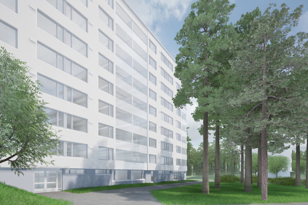 Vaalea, moderni kerrostalo metsäisessä ympäristössä. Rakennuksessa on useita kerroksia ja lasitettuja parvekkeita, ja sen edessä kulkee polku nurmialueen halki. Oikealla puolella kasvaa korkeita mäntyjä.