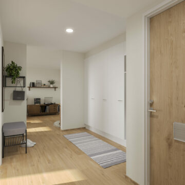 Tilava eteinen, jossa on vaatekaapistot, kokovartalopeili ja kulku olohuoneeseen.